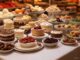 A festive dessert table with various cakes and pastries.