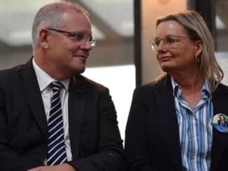 Two professionals in conversation, smiling and making eye contact.