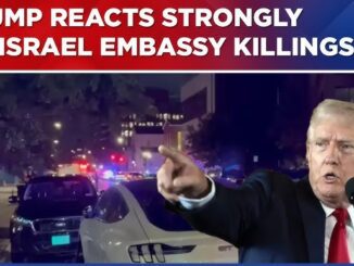 A news reporter covers the strong reaction to the Israel embassy killing with emergency lights in the background.