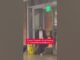 Man in a suit walking out of a building with a news caption about a suspect charged in a fatal shooting.