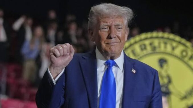 A man in a suit raising his fist with a confident expression. A man in a suit raising his fist with a confident expression.