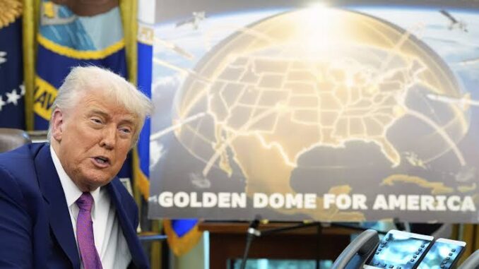 Donald Trump speaking beside a golden dome map of the United States. Donald Trump speaking beside a golden dome map of the United States.