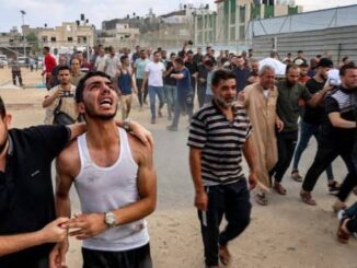 A distressed man surrounded by a crowd in a tense street scene.