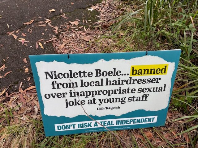 Sign forbidding Nicolette Boele from local hairdresser for inappropriate behavior.
