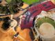 Aerial view of a modern building with curved red roof and surrounding pathways.