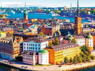A vibrant aerial view of a European city with colorful buildings and waterfront.
