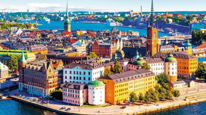 A vibrant aerial view of a European city with colorful buildings and waterfront.
