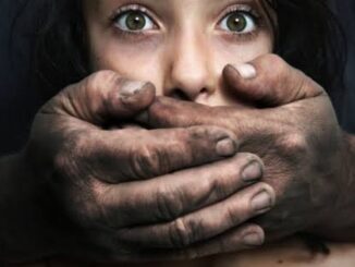 A distressed woman with a dirty hand covering her mouth.