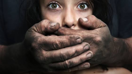 A distressed woman with a dirty hand covering her mouth. A distressed woman with a dirty hand covering her mouth.
