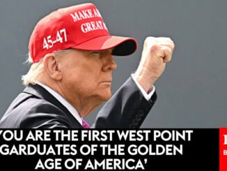 A man in a red 'Make America Great Again' hat raising his fist.