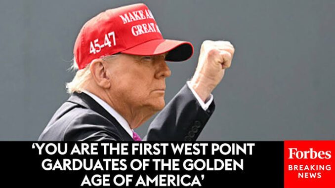 A man in a red 'Make America Great Again' hat raising his fist.