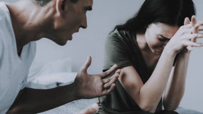 Man angrily confronting a woman who looks distressed and upset.