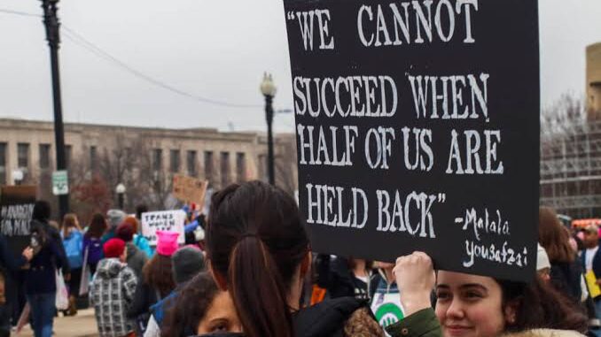 Protesters holding a sign about unity and success. Protesters holding a sign about unity and success.