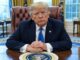 Former President Donald Trump seated at a desk in the Oval Office.