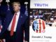 Donald Trump standing near a campaign poster with American flags.