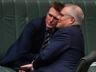 Two men in suits whispering closely in a formal setting.