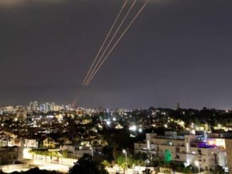 Night cityscape with light trails streaking across the sky.