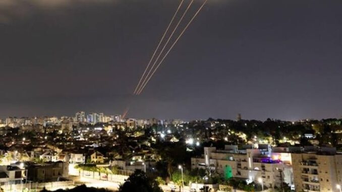 Night cityscape with light trails streaking across the sky. Night cityscape with light trails streaking across the sky.