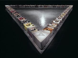 A triangular display of colorful spices in bowls.