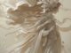 Elegant figure with flowing, ethereal fabric in soft sepia tones.