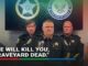 Three stern law enforcement officers at a press briefing.