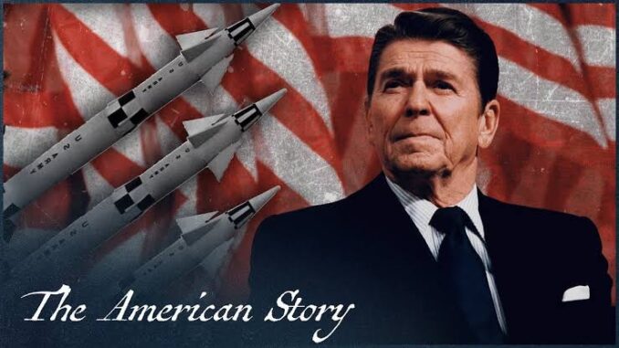 Ronald Reagan with American flag and missiles in background.