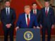 Former President Trump speaks at a podium with the presidential seal, flanked by suited men.