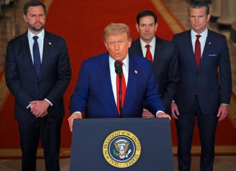 Former President Trump speaks at a podium with the presidential seal, flanked by suited men.