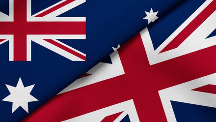 Close-up of Australian and British flags overlapping. Close-up of Australian and British flags overlapping.