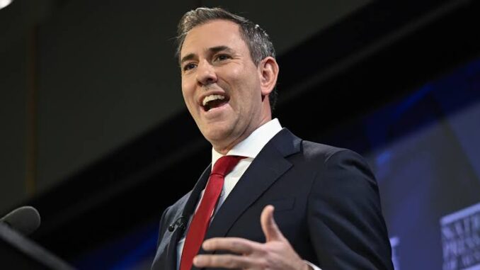 A man in a suit speaking passionately with a smile. A man in a suit speaking passionately with a smile.