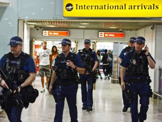 Police officers patrol an international airport terminal.