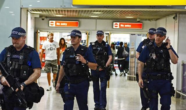 Police officers patrol an international airport terminal.