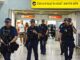 Police officers patrol an international airport terminal.