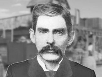 Black and white portrait of a man with a mustache and beard.