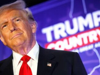 Donald Trump at a Trump County event with a blue background.
