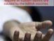 Outstretched hand with controversial vaccine text.