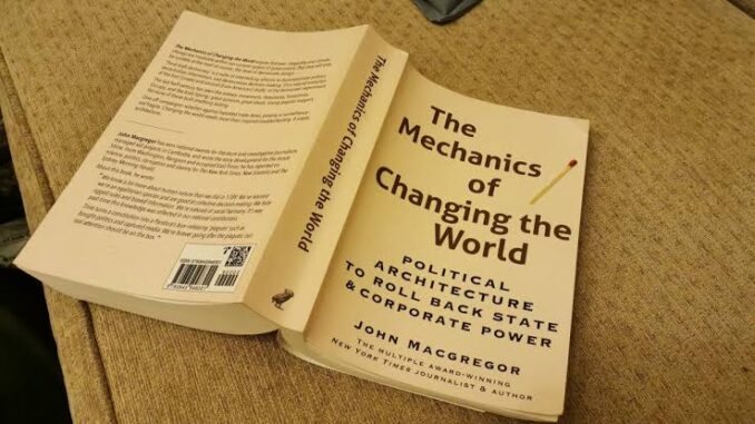 Book titled 'The Mechanics of Changing the Game' on a wooden surface. Book titled 'The Mechanics of Changing the Game' on a wooden surface.