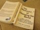 Book titled 'The Mechanics of Changing the Game' on a wooden surface.