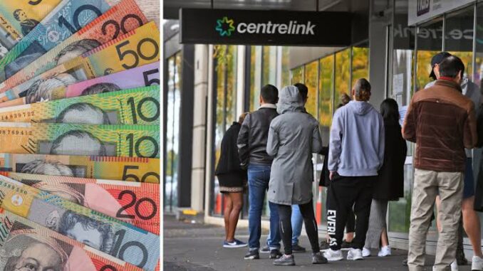 People queue outside a Centrelink office with colorful Australian banknotes nearby. People queue outside a Centrelink office with colorful Australian banknotes nearby.