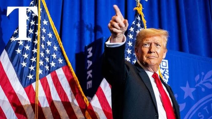 Donald Trump speaking at a podium with US flags behind him. Donald Trump speaking at a podium with US flags behind him.