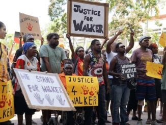 People rallying with signs demanding justice for Walker.