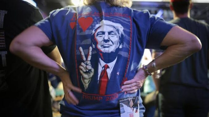 Person wearing shirt with political print design. Person wearing shirt with political print design.
