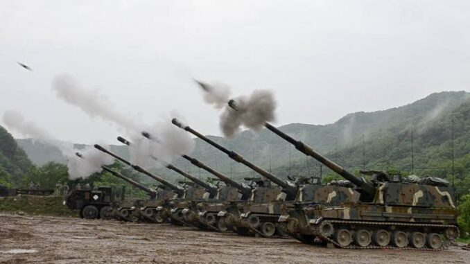 Military tanks firing in a mountainous area. Military tanks firing in a mountainous area.