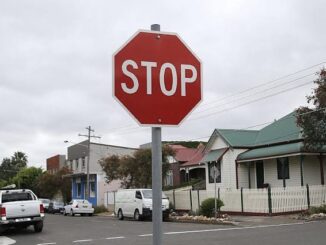 Stop sign on a suburban street corner.