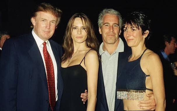 Four people posing together at an event. Four people posing together at an event.