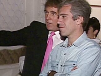 Two men standing and conversing at event.