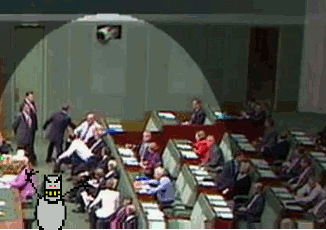 Parliament scene with comedic cartoon cat overlay.