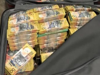 Suitcase filled with stacks of cash.