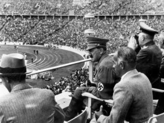 Spectators watching a stadium event, historical scene.