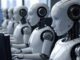 Robots working at computers in an office.